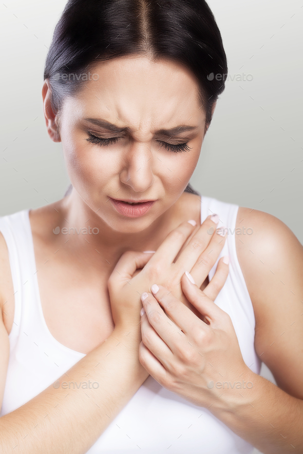 Woman feels severe chest pain. Closeup of a woman's body with a hand